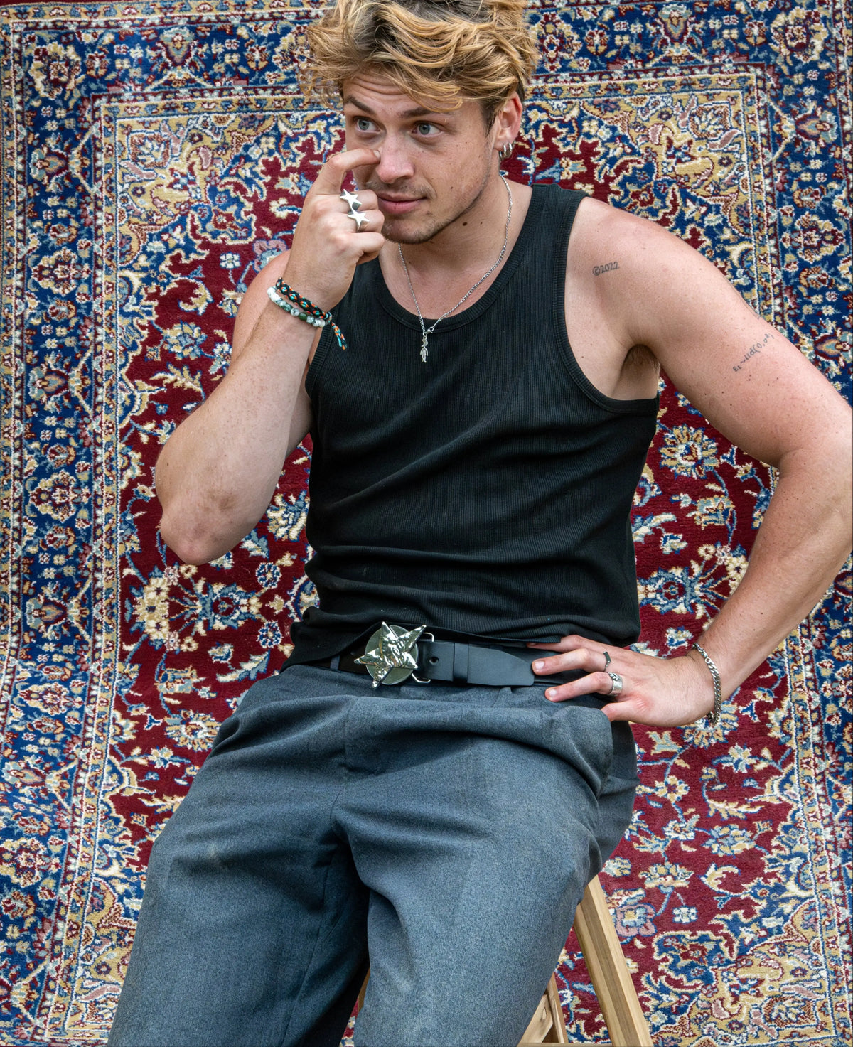 Witse Konings wearing a YUP belt in front of a patterned rug